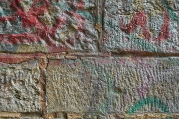 Colored painted stone wall of an old railway underpass.