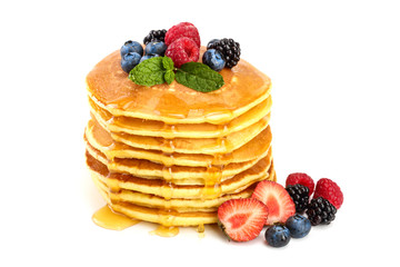 Pancakes stack with different berries and honey isolated on white background