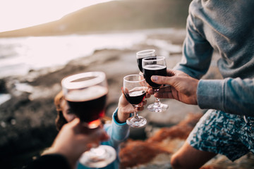 group of friends drinking wine at coast