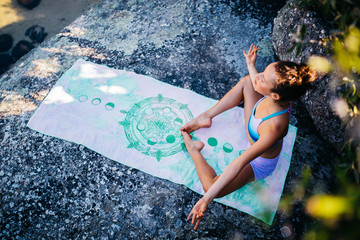 attractive woman doing meditation at beach