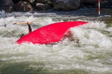 Upset canoe and a paddler under.