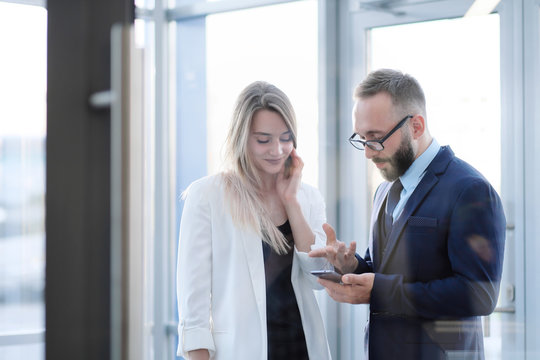 A Man And A Woman At The Entrance To The Office Door Are Talking, Acquaintance.