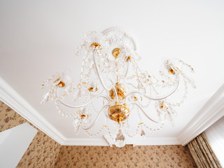 Bottom view on vintage chandelier with crystal pendants.