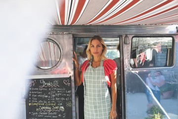 Female waitress standing in food truck