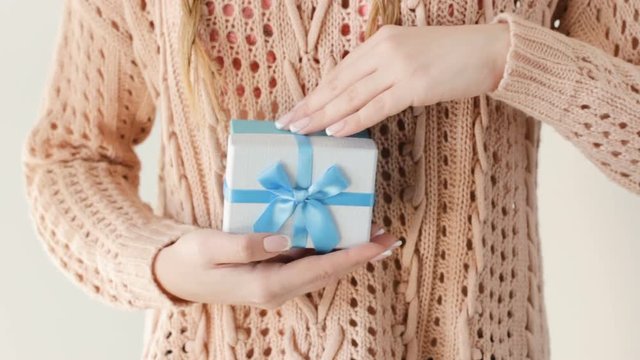 present giving. girl getting a blue gift box from a man. anniversary or birthday congratulation. gratitude and reward concept.