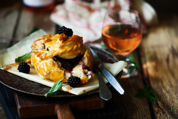Baked brie with blackberry in puff pastry.style rustic