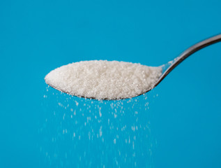 Sugar pouring from a spoon