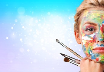 Young beautiful woman with painted face and