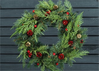 Fototapeta na wymiar Christmas wreath made of fir tree and cones isolated on white