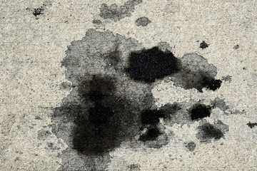 Motor oil stains on concrete pavement/texture background