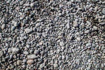 The texture of white river stones. The river of Slovenia with blue water