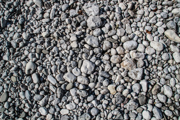The texture of white river stones. The river of Slovenia with blue water