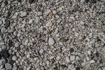 The texture of white river stones. The river of Slovenia with blue water