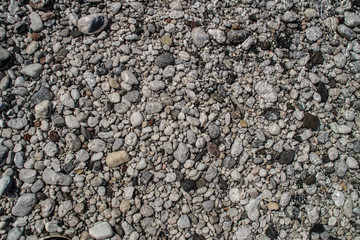 The texture of white river stones. The river of Slovenia with blue water