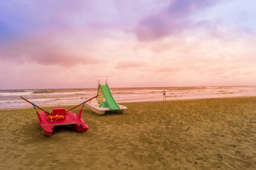 Fototapeta premium rescue boat at sunset at beach on a bad weather day