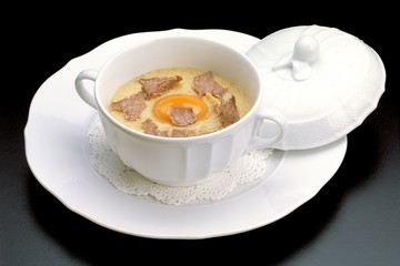 Italian food recipes, traditional Polenta with sliced truffle and raw egg