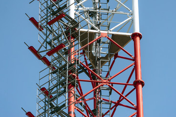 Telephone tower on the sky background, high metal construction