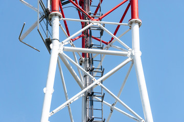 Telephone tower on the sky background, high metal construction