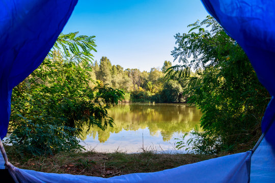 View on the lake from inside of a tent © olyasolodenko