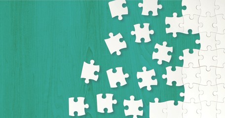 White puzzle pieces on green background