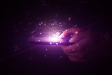 A computer tablet in the hands of a man on a dark background with neon light, a flash of light, magic