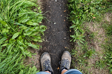 Hiking boot feet on a countryside path