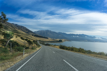 Fototapeta na wymiar Rural Pristine Road in New Zealand South Island With Clear Blue Sky