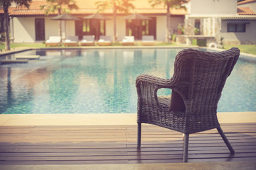 Relaxing rattan chairs beside swimming pool