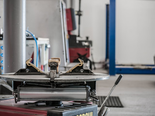 Tire changing machine in a workshop. Tire changing machine closeup.