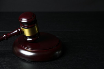 Judge gavel on black wooden background