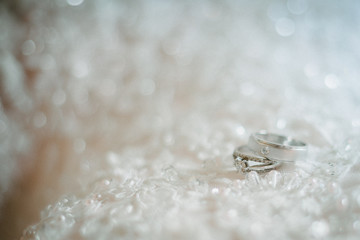 Two wedding rings on a textured background