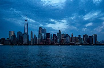 downtown Manhattan lighting up in the evening