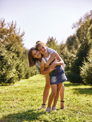 Fototapeta premium Portrait of happy mother and baby girl hugging in park