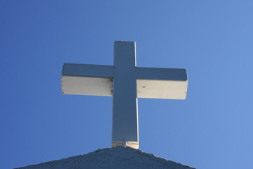 Cycladic greek orthodox church on Paros island, Greece. White cross against blue sky