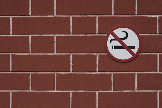 The sign does not smoke on the wall.
