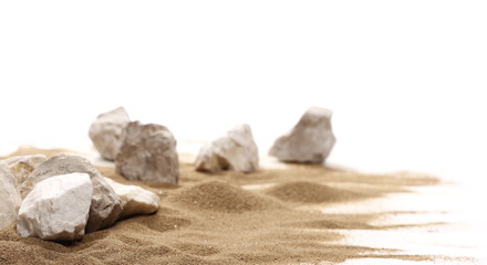 Sea stones in sand pile isolated on white background and texture