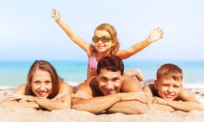 Happy family on vacations on beach background