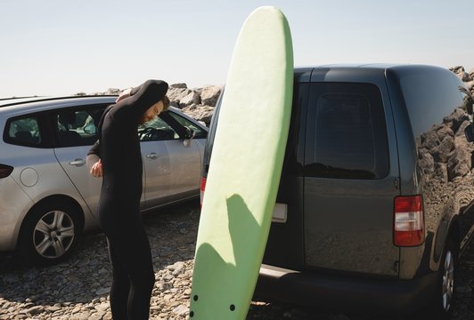 Surfer wearing wetsuit near beach