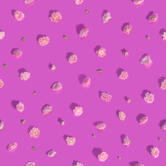 Minimalistic seamless pattern of over 50 different cropped roses, in many hues, studio photographed over reflecting background and isolated on absolute pink color and long shadows