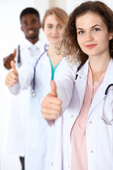 Medical team of confident doctors showing Ok sign with thumbs up. Medicine and health care, insurance concept