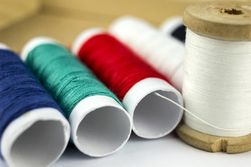 Colored threads in coils, on a wooden background