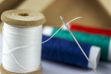 coil thread with a needle threaded into the thread