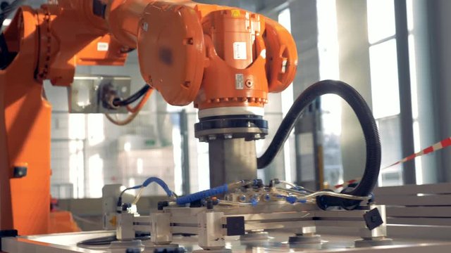 Special robotic arm uses suction cups to drag big panels at a factory.