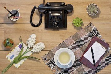 flat lay old phone on table with aircraft, book and passport