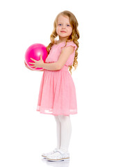 little girl is engaged in fitness with a ball.