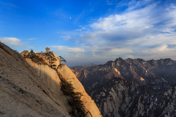 Fototapeta na wymiar Huashan Sunset, Mount Hua - Huayin, near Xi'an in Shaanxi Province China. Chess Playing Pavilion, Pagoda at the top of a Cliff with Steep Vertical Drop-off, Famous yellow granite mountains of China.