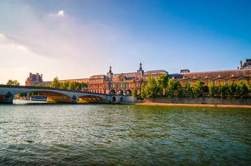 Obraz premium Sunset view on bridge and buildings on the Seine river in Paris, France