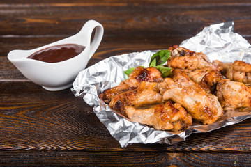 Fried chicken drumstick with barbecue sauce. Pieces of roasted meat. Snack. Meat in sweet and sour sauce
