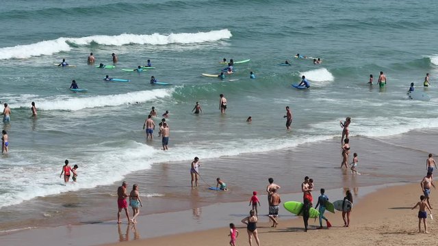 a crowded beach, playa de liencres, in galicia, spain in the summer