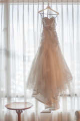 Wedding dress hanging on the window, bridal bride, for the text space